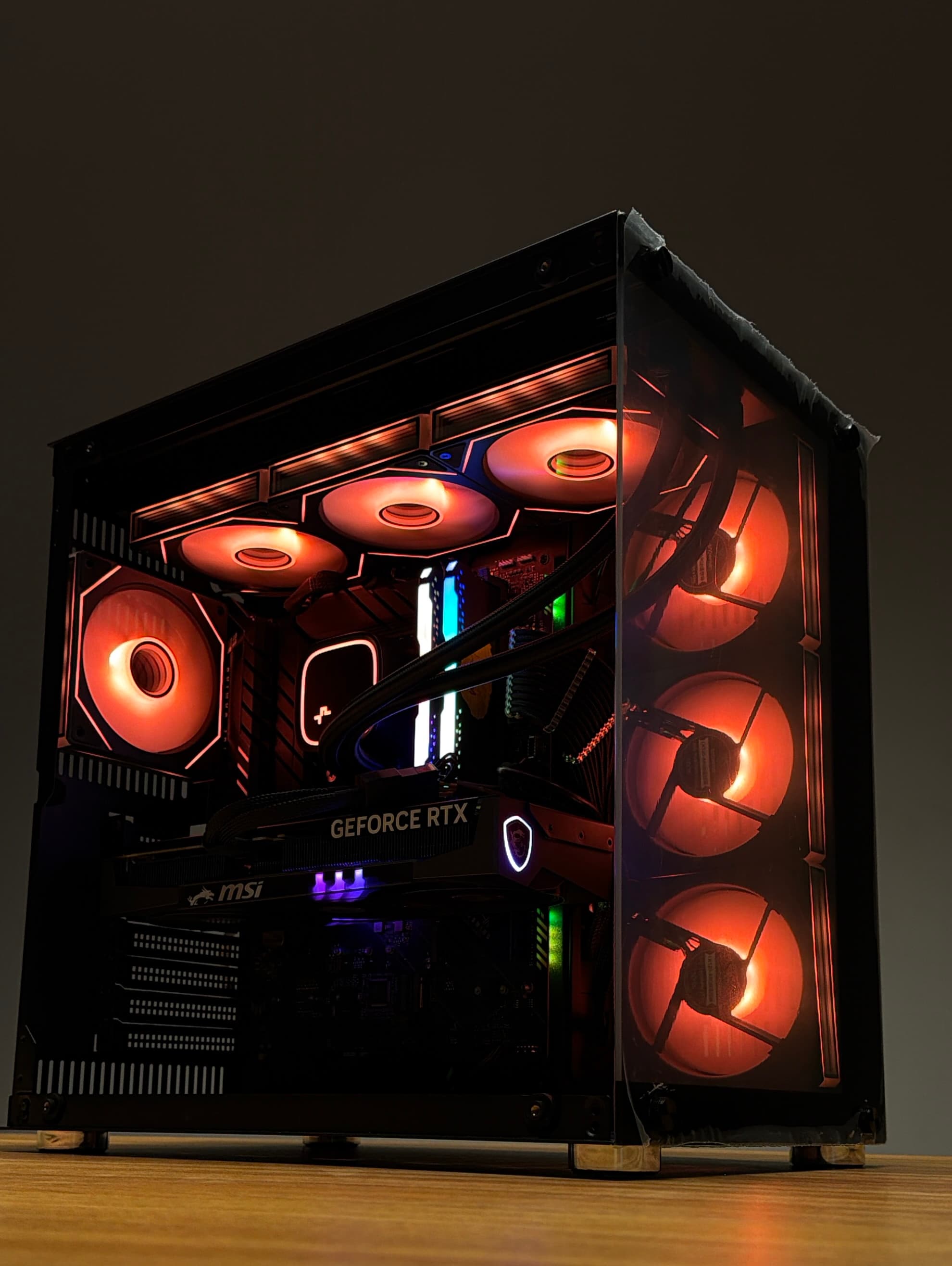 Orange custom gaming PC — hero angle